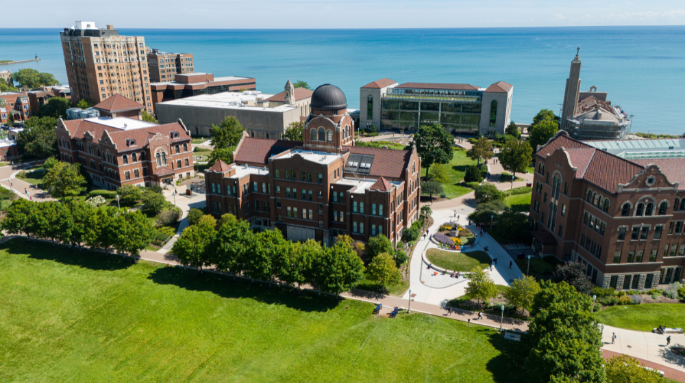 Aerial view of the Cudahy Science Hall with the Information Commons building and Lake Michigan in the background.